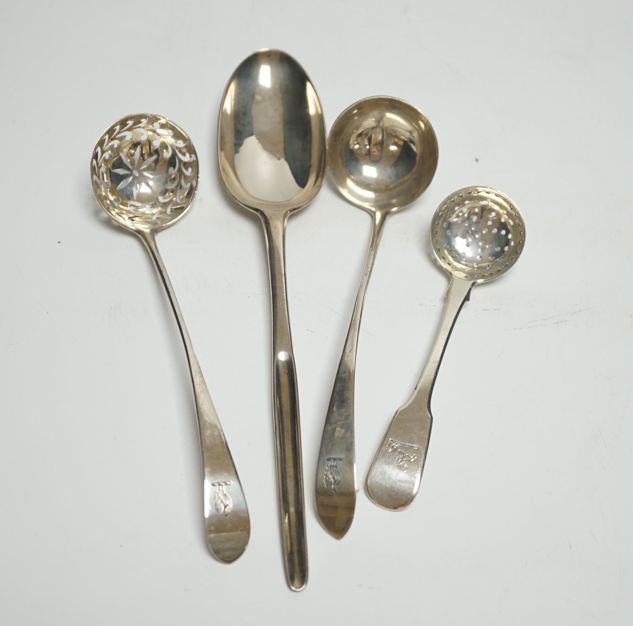 An 18th century silver spoon with marrow scoop handle, indistinct base marks, two silver sifter spoons and a white metal sauce ladle.